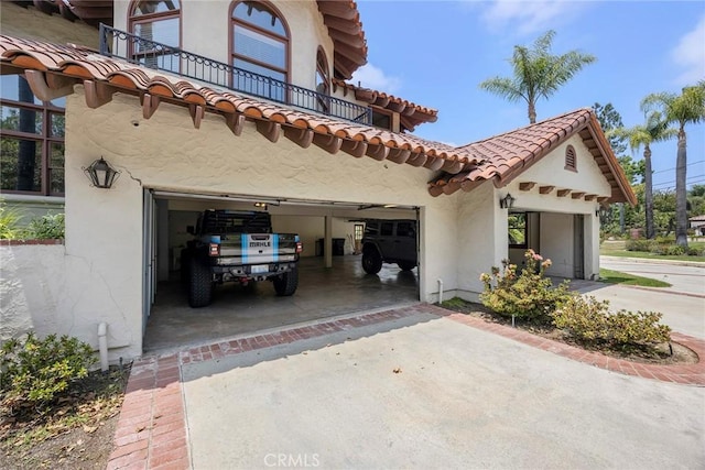 7580 E Martella Ln, Anaheim Hills, CA 92808 - view of side of home with driveway, a balcony, stucco siding, a garage, and a tiled roof
