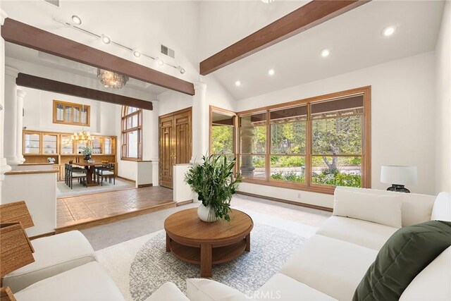 7580 E Martella Ln, Anaheim Hills, CA 92808 - living room with decorative columns, recessed lighting, beamed ceiling, a chandelier, and high vaulted ceiling