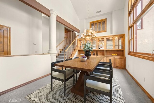 7580 E Martella Ln, Anaheim Hills, CA 92808 - dining area featuring decorative columns, a chandelier, high vaulted ceiling, stairway, and light carpet