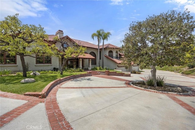 7580 E Martella Ln, Anaheim Hills, CA 92808 - mediterranean / spanish home featuring a tiled roof, a chimney, a front lawn, and stucco siding