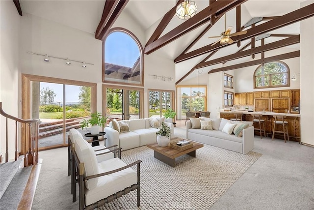 7580 E Martella Ln, Anaheim Hills, CA 92808 - living room with light carpet, high vaulted ceiling, track lighting, beamed ceiling, and plenty of natural light