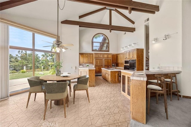 7580 E Martella Ln, Anaheim Hills, CA 92808 - dining room featuring high vaulted ceiling, beamed ceiling, and ceiling fan