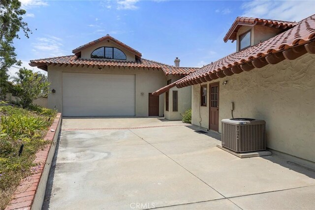 7580 E Martella Ln, Anaheim Hills, CA 92808 - view of front facade featuring driveway, stucco siding, a tile roof, and an attached garage