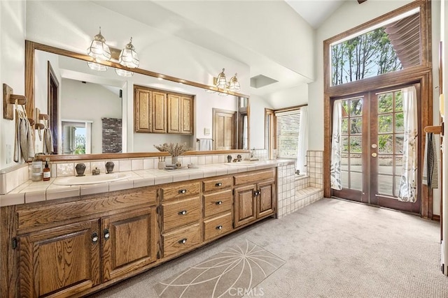 7580 E Martella Ln, Anaheim Hills, CA 92808 - bathroom featuring double vanity, french doors, and high vaulted ceiling