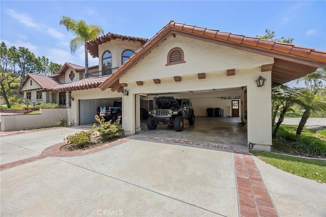 7580 E Martella Ln, Anaheim Hills, CA 92808 - view of front of property with a tiled roof, concrete driveway, stucco siding, a balcony, and an attached garage