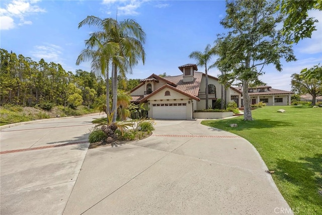 7580 E Martella Ln, Anaheim Hills, CA 92808 - mediterranean / spanish home with an attached garage, driveway, a front lawn, stucco siding, and a tile roof