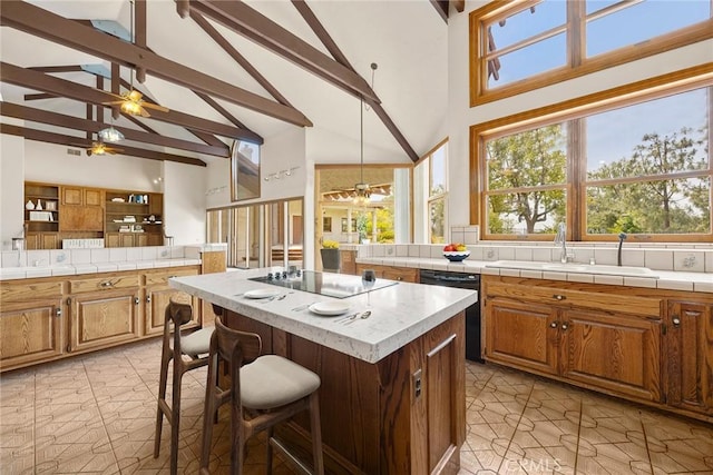 7580 E Martella Ln, Anaheim Hills, CA 92808 - kitchen with black appliances, ceiling fan, high vaulted ceiling, beamed ceiling, and a kitchen island
