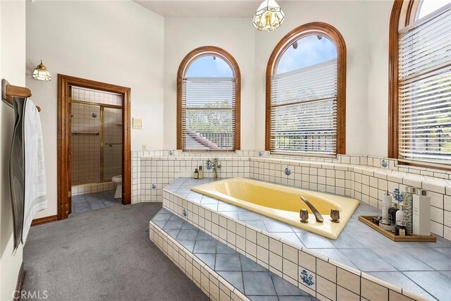 7580 E Martella Ln, Anaheim Hills, CA 92808 - bathroom with a bath, plenty of natural light, a stall shower, and a chandelier