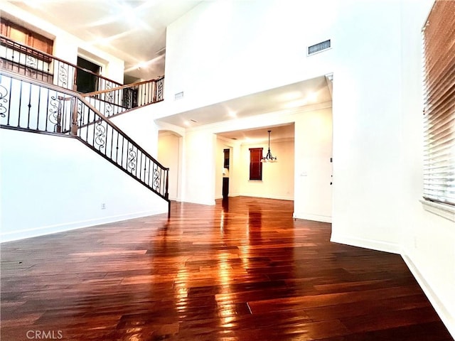 6715 Meriwether Ct, Rancho Cucamonga, CA 91701 - unfurnished living room featuring a high ceiling, hardwood / wood-style floors, and stairway