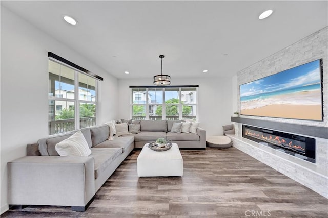 23 Vasto St, Rancho Mission Viejo, CA 92694 - living area featuring wood finished floors, plenty of natural light, recessed lighting, and a glass covered fireplace