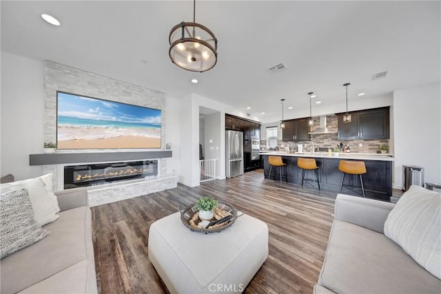 23 Vasto St, Rancho Mission Viejo, CA 92694 - living area featuring dark wood finished floors, a glass covered fireplace, and recessed lighting