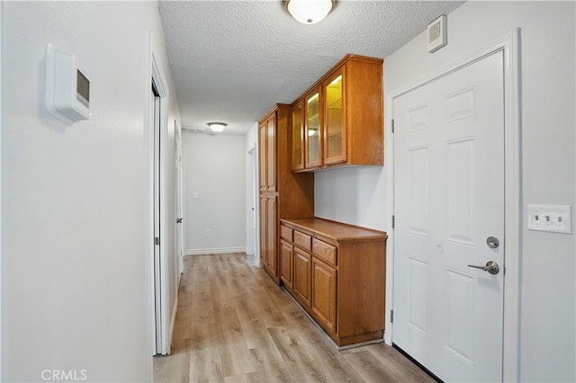28931 Bradley Rd, Menifee, CA 92586 - corridor with light wood-type flooring and a textured ceiling