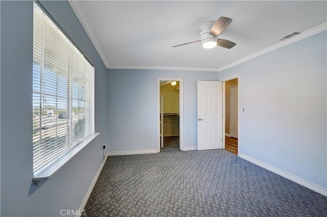28931 Bradley Rd, Menifee, CA 92586 - unfurnished bedroom with carpet flooring, crown molding, a walk in closet, a ceiling fan, and a closet