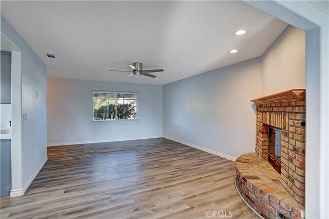 28931 Bradley Rd, Menifee, CA 92586 - unfurnished living room with a ceiling fan, wood finished floors, a brick fireplace, and recessed lighting