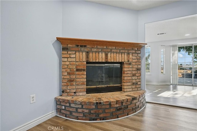28931 Bradley Rd, Menifee, CA 92586 - detailed view of wood finished floors and a brick fireplace
