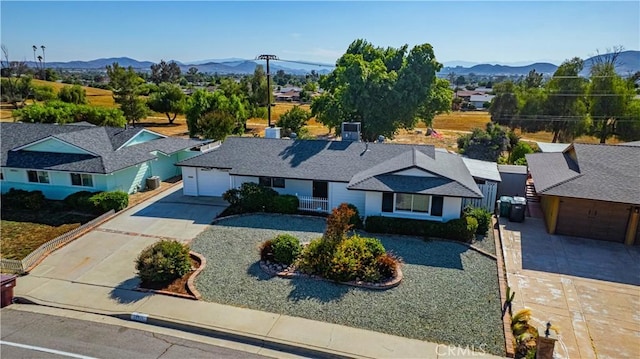 28931 Bradley Rd, Menifee, CA 92586 - view of front of house featuring concrete driveway, a garage, and a mountain view