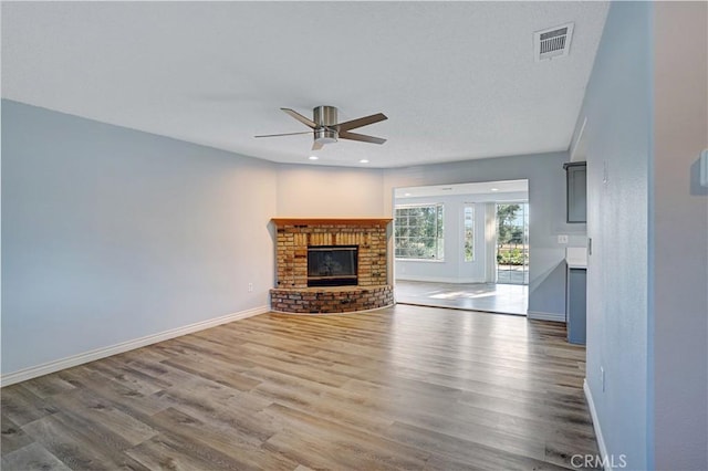 28931 Bradley Rd, Menifee, CA 92586 - unfurnished living room featuring ceiling fan, wood finished floors, a fireplace, and recessed lighting