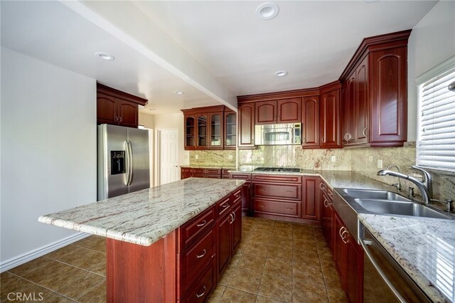 1038 N Columbus Ave, Glendale, CA 91202 - kitchen with stainless steel appliances, dark brown cabinets, backsplash, a center island, and light stone countertops