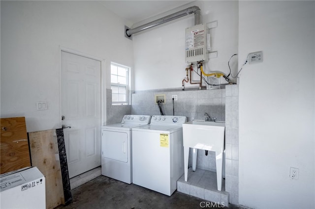 1038 N Columbus Ave, Glendale, CA 91202 - washroom featuring washing machine and clothes dryer, tile walls, and water heater