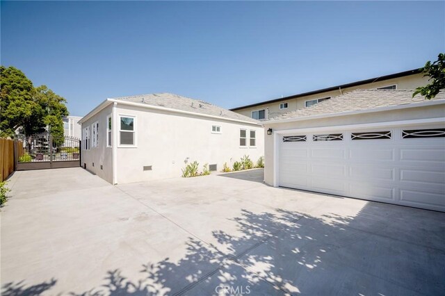 1038 N Columbus Ave, Glendale, CA 91202 - view of property exterior with concrete driveway, stucco siding, and a garage