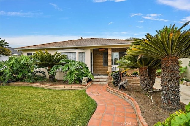 6014 Eckleson St, Lakewood, CA 90713 - view of front of home with a front lawn, a porch, and brick siding