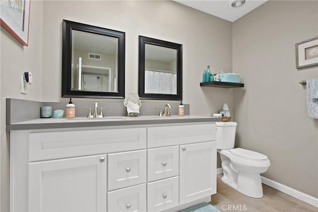 30828 Calle Chueca, San Juan Capistrano, CA 92675 - bathroom featuring double vanity and wood finished floors
