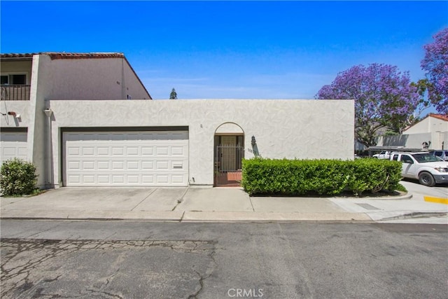 30828 Calle Chueca, San Juan Capistrano, CA 92675 - view of front of house featuring stucco siding, an attached garage, and driveway