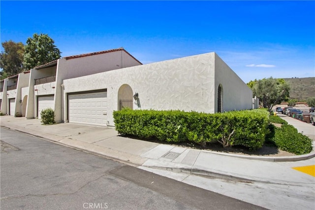30828 Calle Chueca, San Juan Capistrano, CA 92675 - view of front facade with an attached garage, concrete driveway, and stucco siding