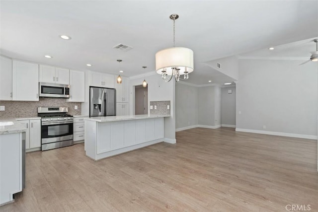 28205 Zurburan, Mission Viejo, CA 92692 - kitchen featuring stainless steel appliances, crown molding, decorative backsplash, open floor plan, and white cabinets