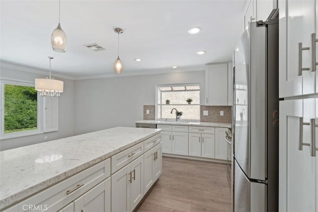 28205 Zurburan, Mission Viejo, CA 92692 - kitchen with stainless steel fridge with ice dispenser, backsplash, light wood-style flooring, light stone counters, and decorative light fixtures