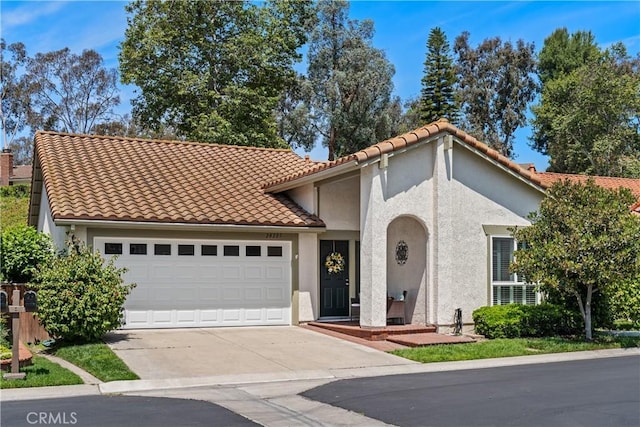 28205 Zurburan, Mission Viejo, CA 92692 - mediterranean / spanish home with a garage, concrete driveway, stucco siding, and a tiled roof