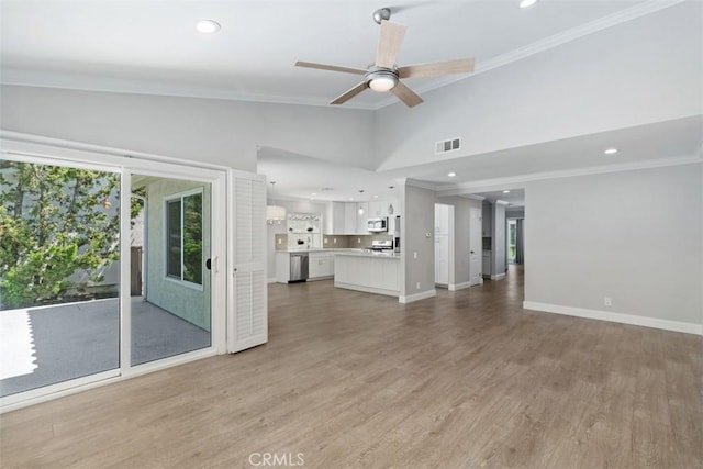 28205 Zurburan, Mission Viejo, CA 92692 - unfurnished living room with crown molding, ceiling fan, lofted ceiling, light wood-type flooring, and recessed lighting