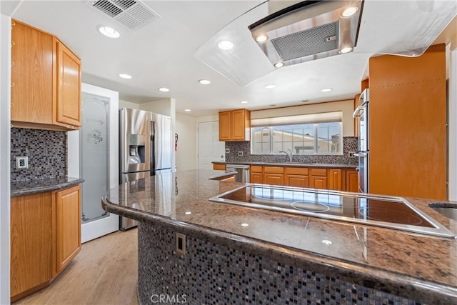 41127 17th St W, Palmdale, CA 93551 - kitchen with stainless steel appliances, light wood-type flooring, backsplash, recessed lighting, and dark stone counters