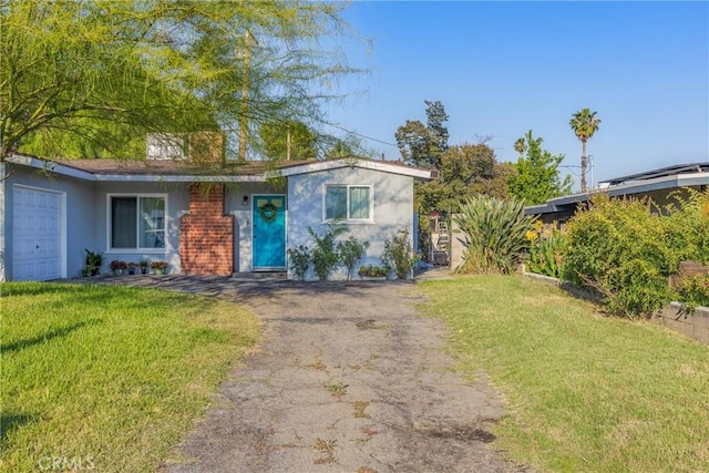 26919 Villa Ave, Highland, CA 92346 - single story home featuring stucco siding, a front yard, asphalt driveway, and an attached garage