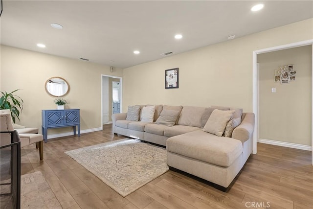 26919 Villa Ave, Highland, CA 92346 - living room featuring light wood finished floors and recessed lighting