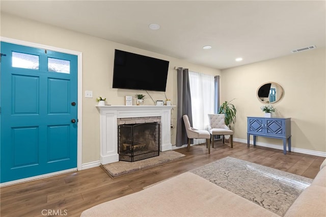 26919 Villa Ave, Highland, CA 92346 - living area with wood finished floors, a fireplace with raised hearth, and recessed lighting