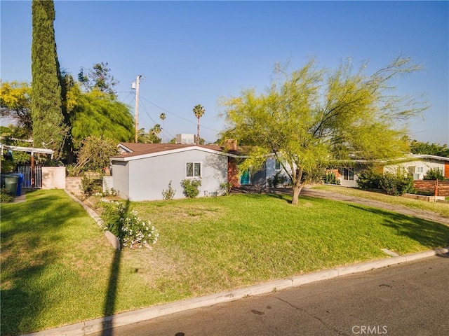 26919 Villa Ave, Highland, CA 92346 - view of front facade featuring a front lawn and stucco siding
