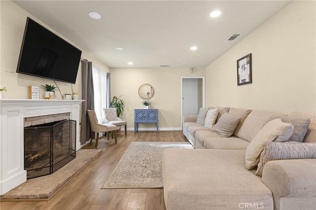 26919 Villa Ave, Highland, CA 92346 - living room with wood-type flooring, recessed lighting, and a brick fireplace