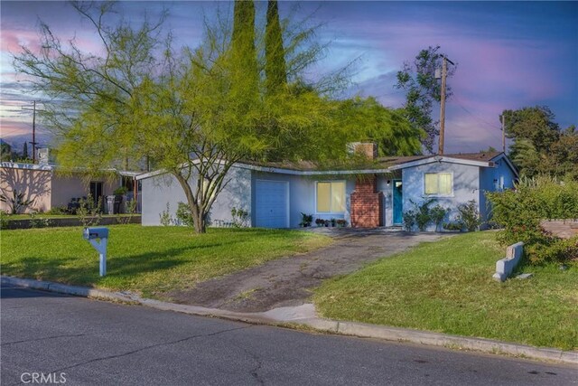 26919 Villa Ave, Highland, CA 92346 - single story home with a lawn, stucco siding, asphalt driveway, and a garage