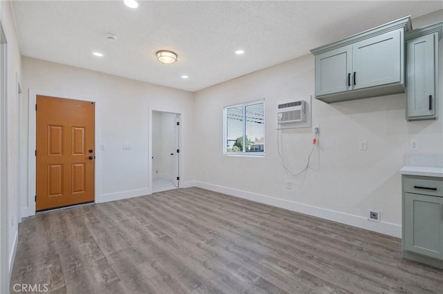 221 N Orchard St, Fresno, CA 93701 - interior space with an AC wall unit, wood finished floors, and recessed lighting