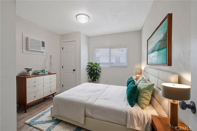 221 N Orchard St, Fresno, CA 93701 - bedroom featuring an AC wall unit and wood finished floors