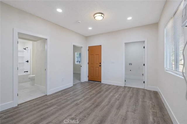 221 N Orchard St, Fresno, CA 93701 - unfurnished bedroom with wood finished floors, ensuite bathroom, and recessed lighting