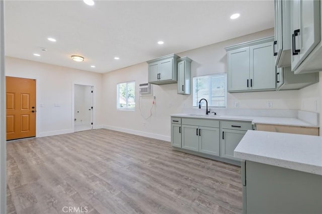 221 N Orchard St, Fresno, CA 93701 - kitchen featuring recessed lighting, light wood-style floors, an AC wall unit, and light stone countertops
