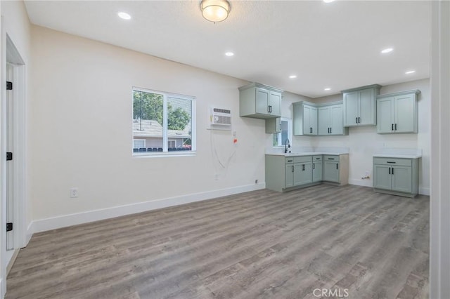 221 N Orchard St, Fresno, CA 93701 - kitchen with an AC wall unit, light wood-style flooring, and recessed lighting