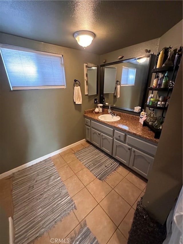 10623 4th Ave, Hesperia, CA 92345 - bathroom featuring tile patterned flooring, a textured ceiling, and vanity