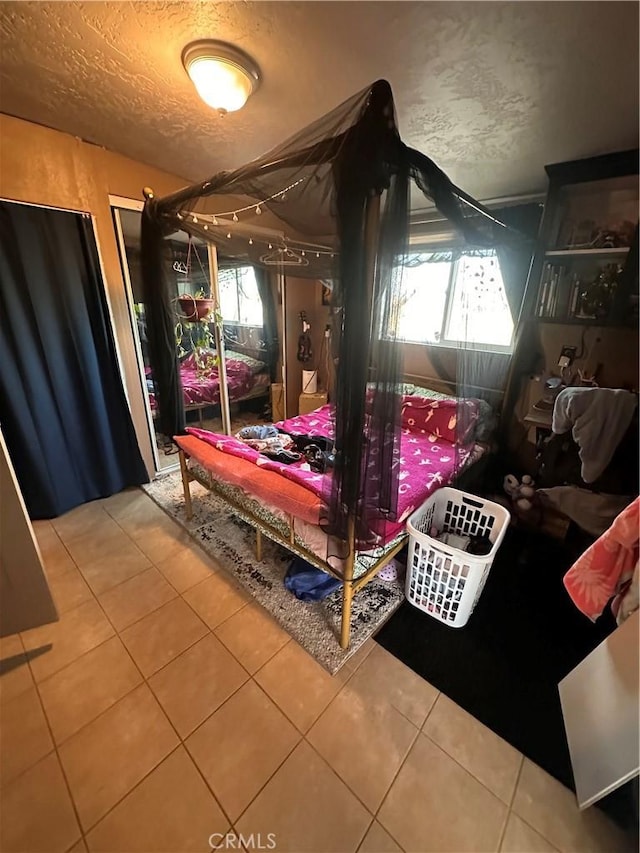 10623 4th Ave, Hesperia, CA 92345 - bedroom with tile patterned flooring and a textured ceiling