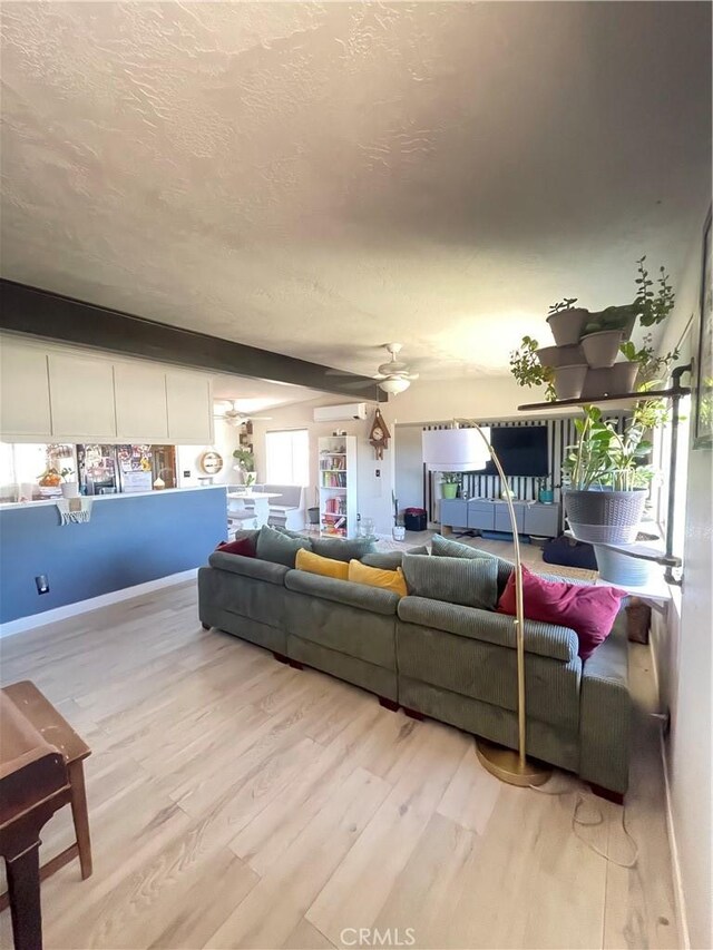 10623 4th Ave, Hesperia, CA 92345 - living room with light wood-style floors, a textured ceiling, and ceiling fan