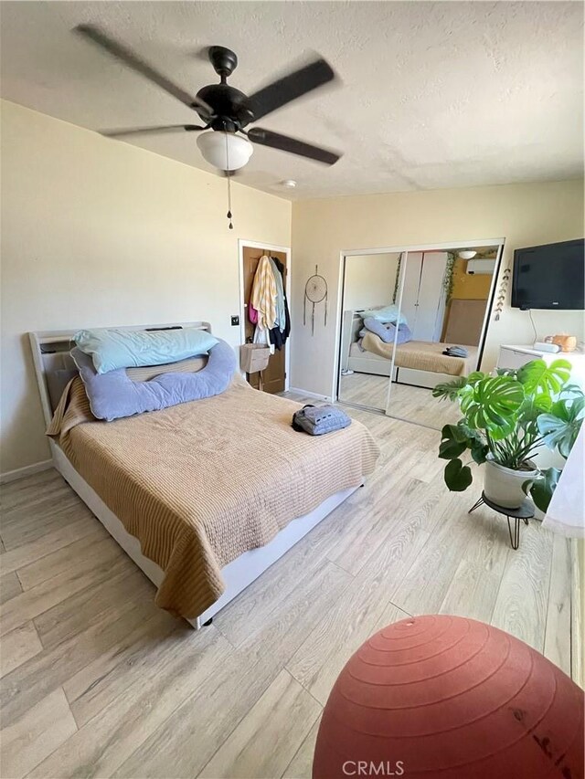 10623 4th Ave, Hesperia, CA 92345 - bedroom featuring wood finished floors, a ceiling fan, and a textured ceiling