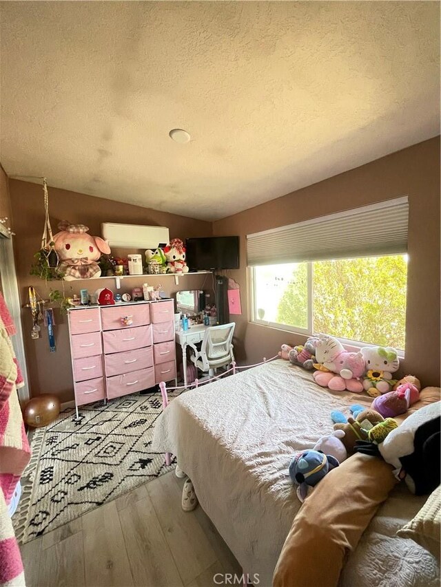 10623 4th Ave, Hesperia, CA 92345 - bedroom featuring wood-type flooring and a textured ceiling