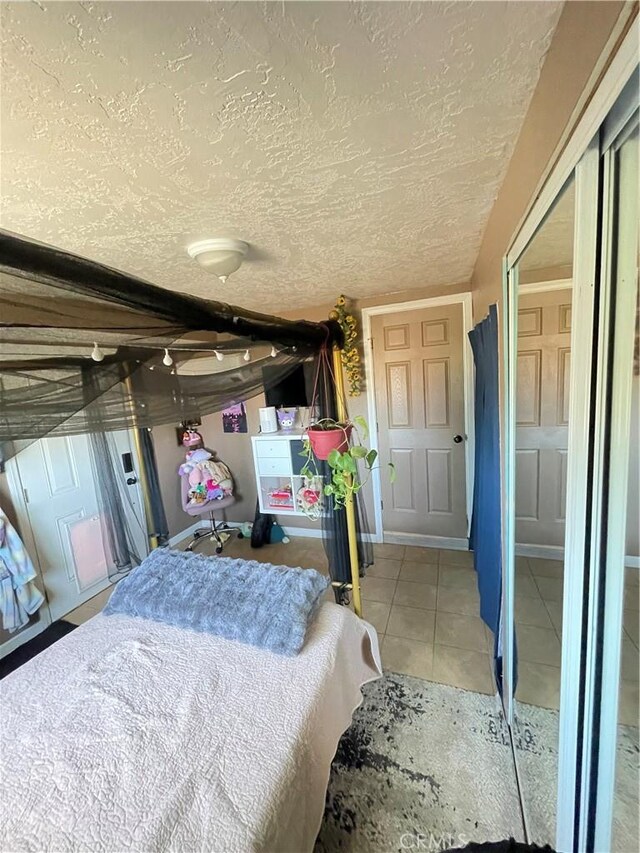 10623 4th Ave, Hesperia, CA 92345 - bedroom with light tile patterned floors and a textured ceiling